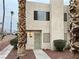 Two-story townhouse with palm trees and walkway at 2611 Aracatuba Ave, Las Vegas, NV 89121