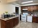 Kitchen with wood cabinets, gas stove, and dishwasher at 2611 Aracatuba Ave, Las Vegas, NV 89121