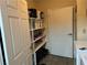 Well-lit laundry room with ample shelving for storage at 2611 Aracatuba Ave, Las Vegas, NV 89121