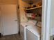 Laundry area with washer, dryer, and shelving at 2611 Aracatuba Ave, Las Vegas, NV 89121