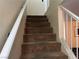 Carpeted stairway with simple white railing at 2611 Aracatuba Ave, Las Vegas, NV 89121