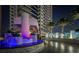 Luxury building entrance featuring water feature, lush landscaping, and porte cochere at 2700 Las Vegas Blvd # 710, Las Vegas, NV 89109