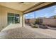 Covered outdoor patio area featuring beautiful brick floors and desert landscaping at 3009 Barrett Springs Ave, Henderson, NV 89044