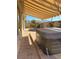 Outdoor hot tub on a brick paver patio, covered by a striped awning in a walled backyard with mountain views at 3009 Barrett Springs Ave, Henderson, NV 89044