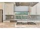 Close-up view of a kitchen featuring stainless steel appliances and a stylish backsplash at 3009 Barrett Springs Ave, Henderson, NV 89044