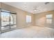 Bright living room with large windows, tile flooring, and neutral decor at 3009 Barrett Springs Ave, Henderson, NV 89044