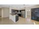 Modern kitchen with dark wood cabinets and stainless steel appliances at 3034 Scenic Valley Way, Henderson, NV 89052