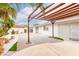 The backyard area features a wood pergola, and palm trees and manicured landscaping at 3127 S Eastern Ave, Las Vegas, NV 89169