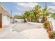 This backyard features a wood pergola, and palm trees and manicured landscaping at 3127 S Eastern Ave, Las Vegas, NV 89169