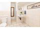 Cozy bathroom featuring tile floors, a wall-mounted sink, and modern fixtures at 3127 S Eastern Ave, Las Vegas, NV 89169