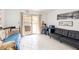 The bonus room features lots of seating, tile flooring, and access to the outdoors at 3127 S Eastern Ave, Las Vegas, NV 89169