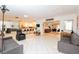 Bright, spacious interior featuring modern tile flooring, multiple seating areas, and a partial kitchen view at 3127 S Eastern Ave, Las Vegas, NV 89169