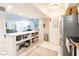 Eat-in kitchen with stainless appliances, an island with shelves, and direct access to a living area at 3127 S Eastern Ave, Las Vegas, NV 89169