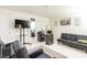 Living room features modern furnishings, an entertainment center with tv, and neutral tones at 3127 S Eastern Ave, Las Vegas, NV 89169