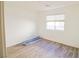 Simple bedroom with wood-look floors and window at 3351 Denali Preserve St, Las Vegas, NV 89122