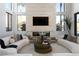 Modern living room boasts a stone accent wall with a fireplace and soaring windows for lots of light at 4377 Cameron Brook Ct, Las Vegas, NV 89129