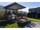 Outdoor kitchen and dining area with modern pergola at 4377 Cameron Brook Ct, Las Vegas, NV 89129