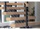 Modern staircase with wood treads and cable railing detail and black iron supports at 4377 Cameron Brook Ct, Las Vegas, NV 89129