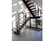 Modern staircase with wood treads and cable railing detail, complemented by a large window at 4377 Cameron Brook Ct, Las Vegas, NV 89129