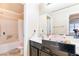 Clean bathroom with a bathtub and double vanity at 5023 Tunnel Falls Dr, Las Vegas, NV 89141