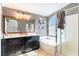 Elegant bathroom with double sinks, soaking tub, and walk-in shower at 5023 Tunnel Falls Dr, Las Vegas, NV 89141