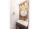 Small bathroom with unique wood wall and round mirror at 5023 Tunnel Falls Dr, Las Vegas, NV 89141