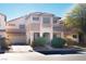 Two-story house with attached garage and desert landscaping at 5023 Tunnel Falls Dr, Las Vegas, NV 89141