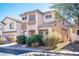 Two-story house with tan exterior and shutters at 5023 Tunnel Falls Dr, Las Vegas, NV 89141
