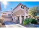 Two-story house with attached garage and desert landscaping at 5023 Tunnel Falls Dr, Las Vegas, NV 89141