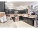 Spacious kitchen with dark wood cabinets and granite countertops at 5023 Tunnel Falls Dr, Las Vegas, NV 89141