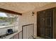 Exterior view of front door with black trim, adjacent to carport and stairs at 5262 Osman Ct # 48, Las Vegas, NV 89103