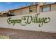 The community's welcome sign is in an elegant font, set against a clean white brick wall at 5262 Osman Ct # 48, Las Vegas, NV 89103