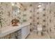 Bathroom with floral wallpaper, white vanity, and a toilet at 5416 Lochmor Ave, Las Vegas, NV 89130