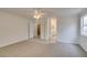 Spacious bedroom featuring plush carpeting, ceiling fan, and access to a bright bathroom at 5416 Lochmor Ave, Las Vegas, NV 89130