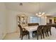Bright dining room features tile flooring, large windows, and elegant chandelier lighting at 5416 Lochmor Ave, Las Vegas, NV 89130