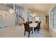 Bright dining room features tile flooring, large windows, and elegant chandelier lighting at 5416 Lochmor Ave, Las Vegas, NV 89130
