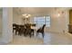 Bright dining room features tile flooring, large windows, and elegant chandelier lighting at 5416 Lochmor Ave, Las Vegas, NV 89130