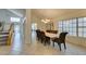 Bright dining room features tile flooring, large windows, and elegant chandelier lighting at 5416 Lochmor Ave, Las Vegas, NV 89130