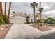 Inviting single-story home with desert landscaping and mature palm trees at 5416 Lochmor Ave, Las Vegas, NV 89130