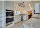 Kitchen featuring stainless steel appliances, white cabinets, and tile floors at 5416 Lochmor Ave, Las Vegas, NV 89130