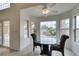 Cozy breakfast nook with natural light, tile floors and windows with views of the landscaped yard at 5416 Lochmor Ave, Las Vegas, NV 89130