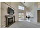 Living room with fireplace, TV, and sliding glass doors to the backyard patio for indoor-outdoor living at 5416 Lochmor Ave, Las Vegas, NV 89130