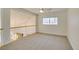 Upstairs space featuring neutral carpeting, large window offering lots of natural light, and white trim at 5416 Lochmor Ave, Las Vegas, NV 89130