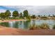 Scenic view of a tranquil pond featuring lush greenery, a fountain, and serene water features at 5416 Lochmor Ave, Las Vegas, NV 89130