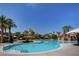 Large resort-style pool with palm trees and lounge areas at 56 Island Course Ave, Las Vegas, NV 89148