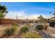 Beautiful backyard with mature desert landscaping, stone accents and a charming privacy wall at 5615 Criollo Dr, Las Vegas, NV 89122