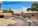 Landscaped backyard featuring desert plants, stone accents and a brick-paved patio area at 5615 Criollo Dr, Las Vegas, NV 89122