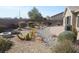 Landscaped backyard with fire pit and rock garden at 5615 Criollo Dr, Las Vegas, NV 89122