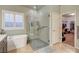 Bathroom featuring soaker tub, shower with glass door, and access to a large closet at 5615 Criollo Dr, Las Vegas, NV 89122