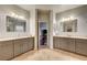 Luxurious bathroom featuring dual vanities, decorative mirrors, and neutral paint at 5615 Criollo Dr, Las Vegas, NV 89122